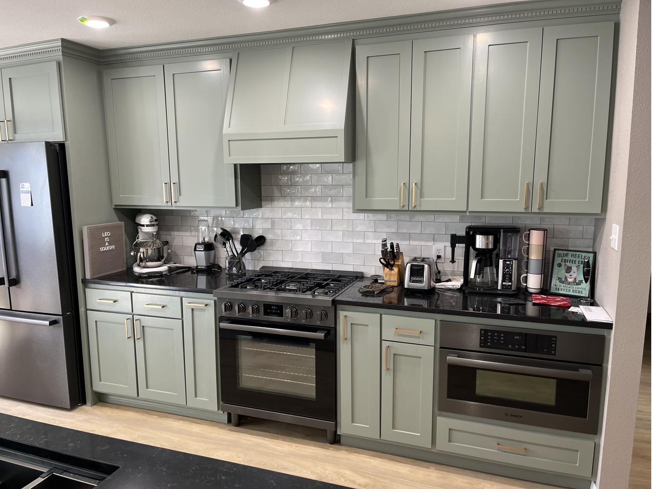 Sage green shaker kitchen with subway tile