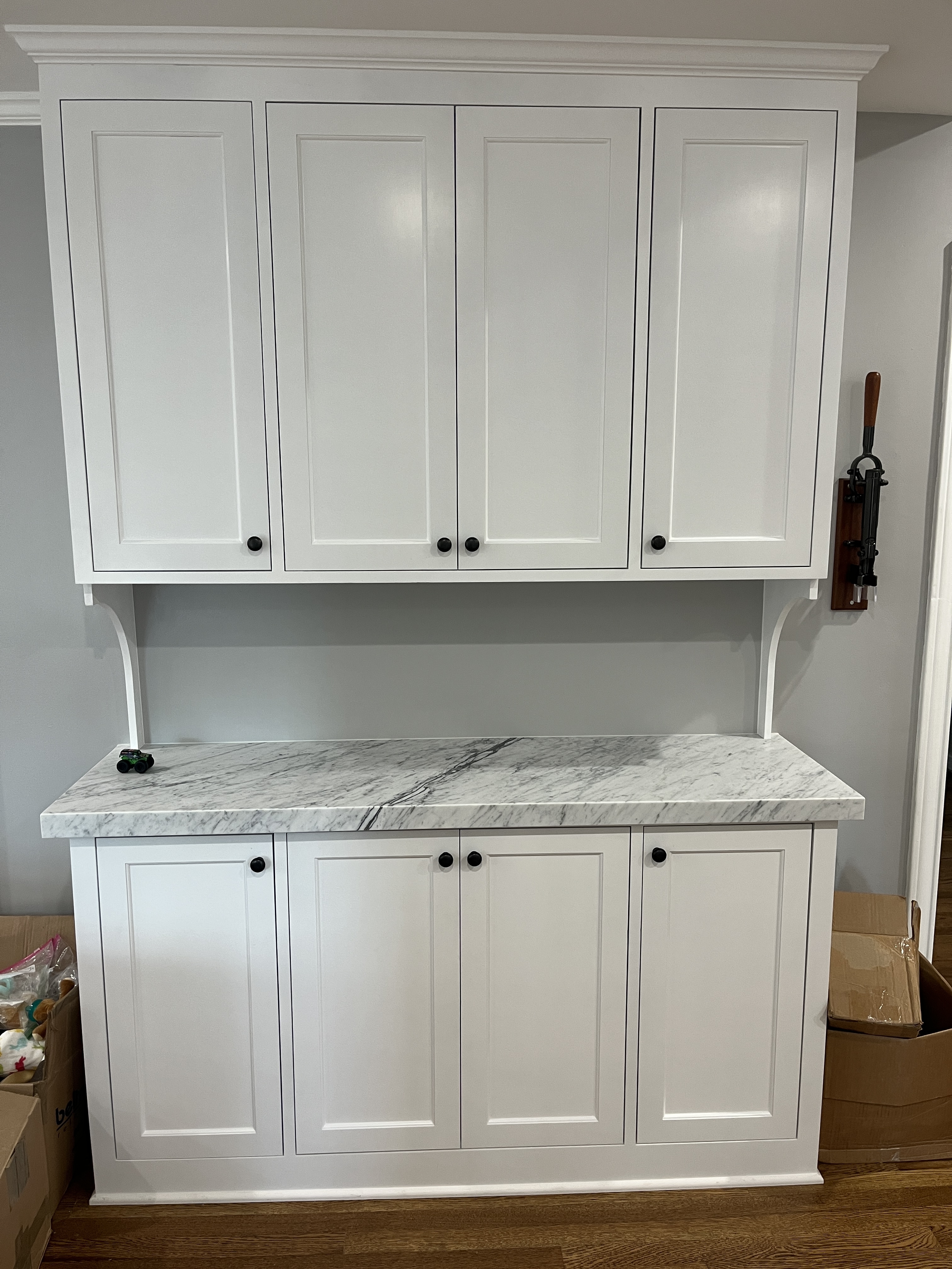 White marble-topped hutch with arched corbels